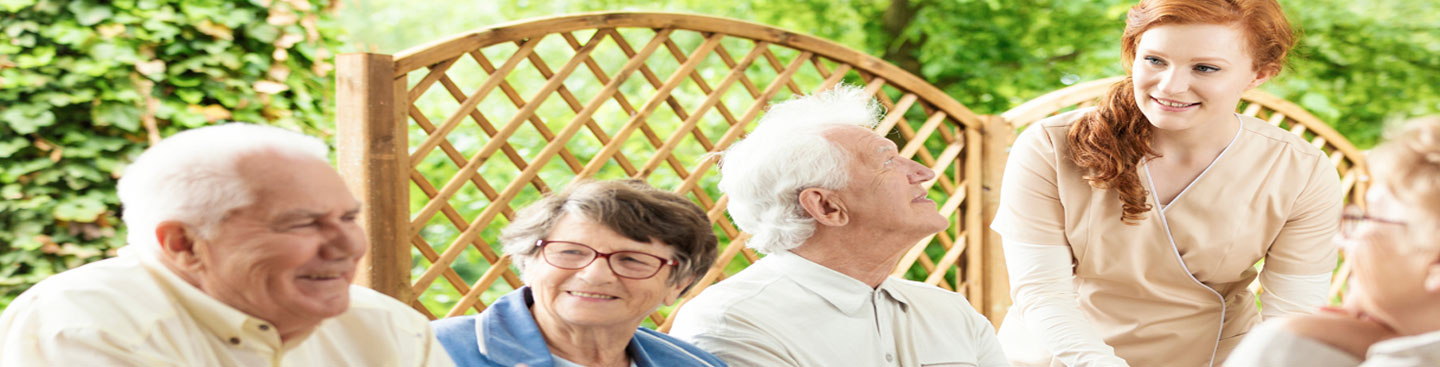Photo of Seniors at a Table with Care Giver